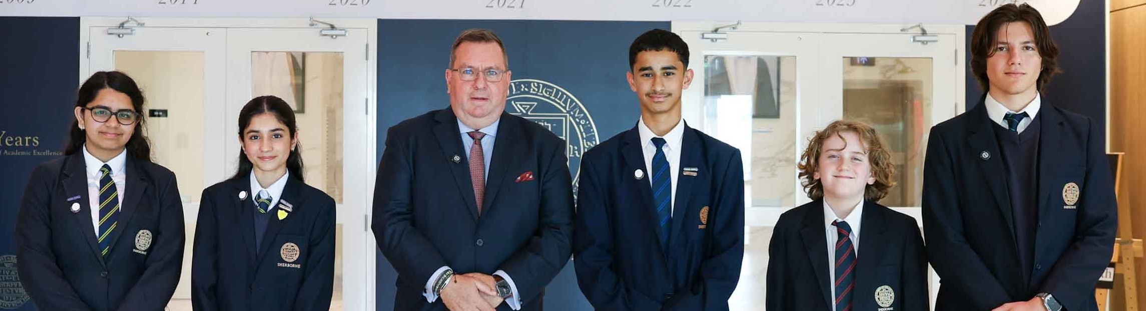 Senior school pupil with some art work at Sherborne Qatar